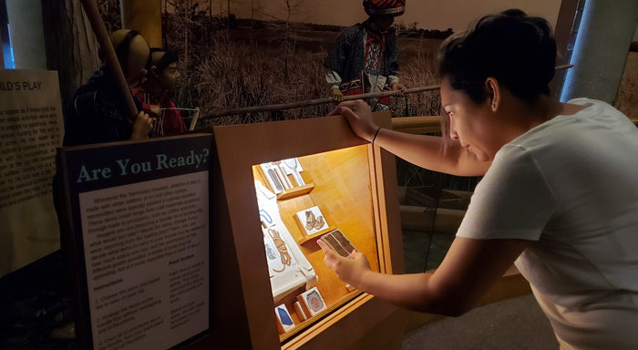 An adult playing with an interactive called “Are You Ready” at the Ah-Tah-Thi-Ki Museum.