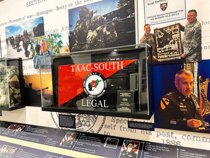 Custom display case featuring a plaque from Iraq at the OTJAG exhibit in the Pentagon